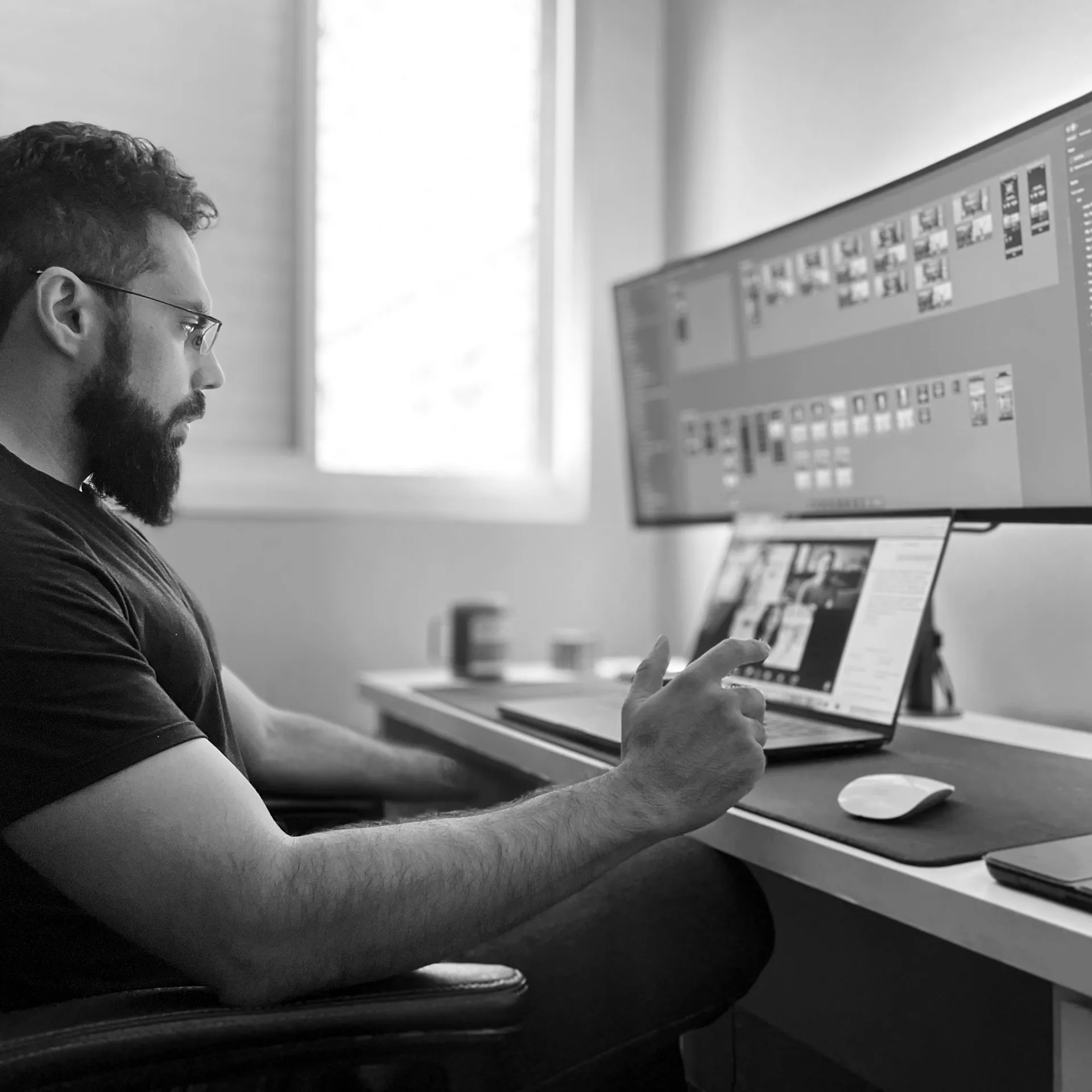 Andrei Carvalho at his desk, working on a design file